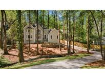 Charming two-story home nestled among mature trees, featuring elegant architectural details and a private setting at 1183 Woods Ne Cir, Atlanta, GA 30324
