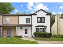 Charming two-story home with well-manicured lawn, lovely landscaping, and inviting entryway at 2896 Lakemont Sw Dr, Marietta, GA 30060