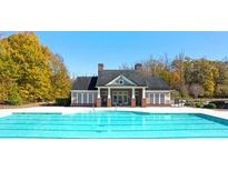 Stunning community pool with an adjacent clubhouse surrounded by lush trees, creating a perfect oasis at 13579 Whitman Ln, Covington, GA 30014