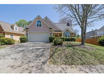 Charming home features a well-maintained front yard and two-car garage at 2500 Waterstone Way, Marietta, GA 30062
