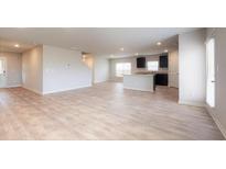 Open-concept living room featuring hardwood floors, recessed lighting, and neutral paint at 164 Weldon Rd, Mcdonough, GA 30253