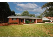 Charming brick home with a well-manicured lawn and inviting front porch at 2533 Whispering Pines Dr, Grayson, GA 30017