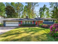 Charming single-story home featuring a lush front lawn, gray siding, and brick accents at 3325 N Embry Cir, Atlanta, GA 30341