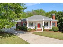 Charming single-story brick home with a welcoming front porch and beautifully landscaped yard at 7019 Morningside Ct, Douglasville, GA 30134