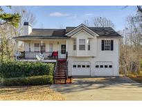 Charming two-story home featuring a spacious front porch, two-car garage, and landscaped yard at 674 Fairview Dr, Dallas, GA 30157