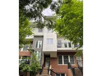 Contemporary multi-story townhouse featuring a red brick facade and upper-level balcony at 745 Fountainhead Ne Ln # 112, Atlanta, GA 30324