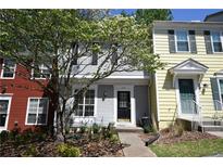 Charming two-story townhome featuring a well-maintained lawn and beautiful landscaping with a blooming tree at 1102 Wedgewood Way, Atlanta, GA 30350