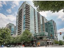 Modern high-rise condo building with balconies, and a restaurant on street level at 943 Peachtree Ne St # 1910, Atlanta, GA 30309