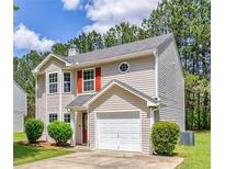 Charming two-story home featuring a single-car garage, red shutters, and well-maintained landscaping in a suburban setting at 2075 Ivy Ln, Union City, GA 30291