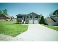Charming two-story home with a well-manicured lawn and a two-car garage at 660 Allens Landing Dr, Lawrenceville, GA 30045