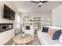 Cozy living room featuring a plush sofa, stylish decor, and a modern fireplace at 149 Weldon Rd, Mcdonough, GA 30253