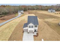Newly built two-story home with attached two-car garage and a spacious front yard at 209 Weldon, Mcdonough, GA 30253