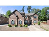 Charming brick home with manicured landscaping and symmetrical design elements, offering classic curb appeal and timeless elegance at 2745 Veltre Sw Ter, Atlanta, GA 30311