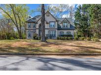 Charming two-story home with a well-manicured front yard and mature trees at 3139 Players Dr, Jonesboro, GA 30236