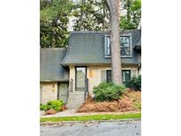 Charming townhome featuring a well-manicured front yard and traditional architectural details at 102 Adrian Nw Pl, Atlanta, GA 30327