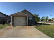 Single-car garage with driveway, situated on a well-maintained lawn and curb appeal at 2362 Glebe Ct, Hampton, GA 30228