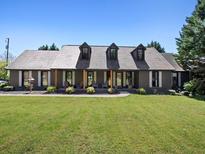 Charming single-story home with dormer windows, a well-maintained lawn, and inviting curb appeal at 3919 Evans Rd, Cumming, GA 30040