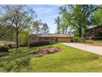Charming ranch home with a well-manicured lawn, inviting front porch and two car garage at 2691 Whippoorwill Cir, Duluth, GA 30097