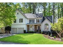 Charming two-story home featuring a well-manicured lawn and an attached two-car garage at 4414 Aldenham Nw Way, Suwanee, GA 30024