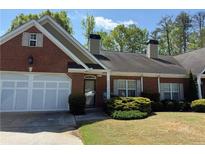 Charming brick home with a well-maintained lawn, attached garage, and a cozy front entrance at 2575 Rosehill Circle, Lithia Springs, GA 30122