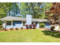 Charming single story home with blue siding, a well-manicured lawn, and mature landscaping at 108 Dove, Peachtree City, GA 30269