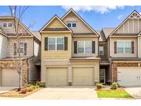 Charming townhome featuring a two-car garage and neutral-toned exterior at 1546 Silvaner Nw Ave # 20, Kennesaw, GA 30152