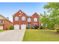 Beautiful two-story brick home with a well-manicured lawn and two-car garage at 3311 Keenland Rd, Marietta, GA 30062