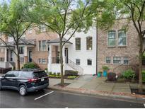 Charming townhome exterior with a manicured lawn and front yard in a desirable neighborhood at 3932 Boston Common St, Suwanee, GA 30024