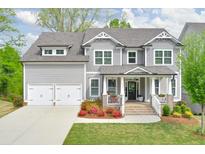 Charming two-story home featuring a landscaped yard and a two-car garage with a gray paint scheme at 412 Nickajack Retreat Ln, Smyrna, GA 30082
