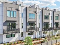 Beautiful exterior of modern townhomes with gray and white siding and private balconies on multiple levels at 443 Plateau Nw Pl, Atlanta, GA 30309