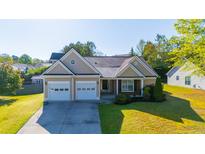 Charming single-Gathering home featuring a two-car garage and a well-manicured front lawn at 1910 Charleston Oak Cir, Lawrenceville, GA 30043