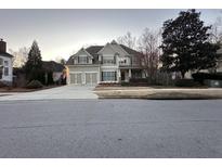 Charming two-story home features a three-car garage and beautiful landscaping at 4106 Creekview Ridge Ne Dr, Buford, GA 30518