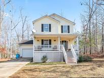 Charming two-story home featuring a welcoming front porch and well-maintained yard at 45 Hunters Ridge Ct, Covington, GA 30014