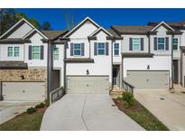 Charming townhome with neutral paint, driveway, and attached garages in a desirable neighborhood at 518 Scenic Pass, Woodstock, GA 30189