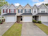 Charming townhomes featuring varied exterior color schemes, attached garages, and manicured landscaping at 6703 Gallant Se Ct, Mableton, GA 30126