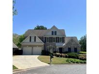 Charming two-story home with a brick facade, a two-car garage, and well-maintained landscaping at 2384 Briarleigh Way, Dunwoody, GA 30338