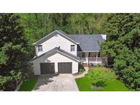 Charming two-story home with a two car garage and a quaint front porch at 5245 Cherry Hill Ln, Powder Springs, GA 30127
