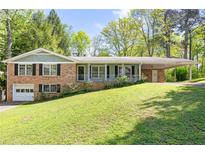 Charming brick home with an attached carport and garage at 120 Westwood Nw Dr, Marietta, GA 30064