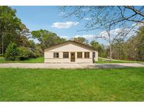 Charming single story home with spacious yard, concrete driveway, and mature trees at 961 Old Conyers Rd, Stockbridge, GA 30281