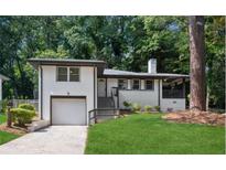 Charming exterior elevation featuring a garage and landscaped front yard perfect for a Gathering at 1753 Detroit Nw Ave, Atlanta, GA 30314