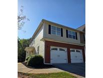 View of exterior highlighting brick and siding with a two-car garage and landscaping at 1960 Dakota Nw Dr, Acworth, GA 30101