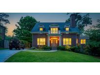 Charming brick home with manicured lawn, lush landscaping, and inviting entrance, perfect for suburban living at 1116 Dan Johnson Ne Rd, Atlanta, GA 30307