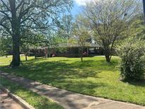 Charming one-story brick home with a well-manicured lawn and mature trees in a desirable neighborhood at 2667 Wenatchee Dr, Marietta, GA 30066
