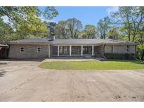 Charming one-story home featuring a stone facade, covered porch, and a spacious front yard at 2806 Chaucer Sw Dr, Atlanta, GA 30311