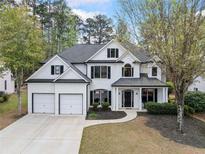 Charming two-story home with a well-manicured lawn and attached two car garage at 13070 Tidewater Xing, Alpharetta, GA 30005