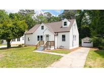 Charming home with fresh white siding, well-kept lawn and private detached garage at 1282 Eastridge Sw Rd, Atlanta, GA 30311
