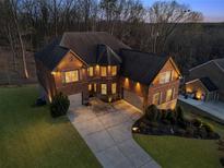Stunning brick home with a two-car garage, lush landscaping, and a spacious driveway, providing ample parking at 4538 Sterling Pointe Nw Dr, Kennesaw, GA 30152