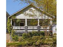 Charming home with a welcoming front porch framed by lush landscaping in a desirable location at 136 Flora Ne Ave, Atlanta, GA 30307