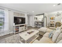 Inviting living room featuring neutral paint, a large TV, stylish decor, and comfortable seating at 6820 Glenridge Dr # C, Sandy Springs, GA 30328