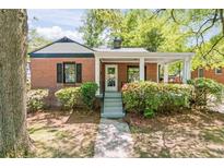 Charming brick home with a welcoming front porch and well-maintained landscaping at 1700 John Calvin Ave, Atlanta, GA 30337